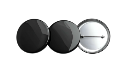 Three black round badges, two face-up, one revealing the pin backing, on a dark backdrop