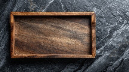 A wooden tray sits on a dark stone surface with visible patterns. The natural features of both materials stand out in the light. This scene captures a simple everyday moment.