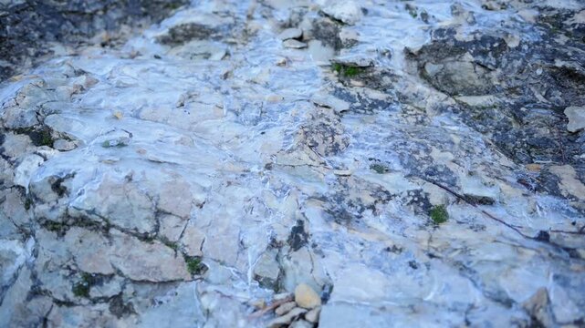 Close-Up of Clear Ice Formation on Rugged Rocks, Revealing a Cold Winter Nature Scene