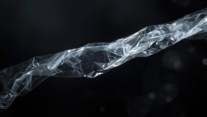 Plastic wrap with creased surface on dark background serving as a textured backdrop for graphic design projects