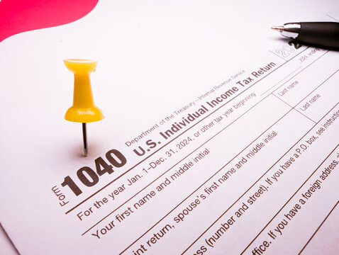 us tax form 2026 1040 with yellow pushpin and pen for income tax filing and financial documentation