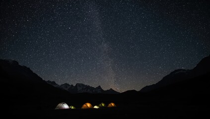 Nighttime camping scene with glowing tents amid mountain peaks, adventure and wilderness