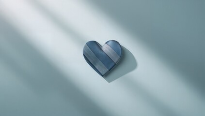 Blue necktie shaped like a heart placed on a light pastel background, ideal for Fathers Day celebration