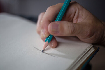 Close-up hand tracing line with the pencil on the paper © Gabrielli