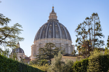 View of the dome of St. Peter's Basilica, seen from the Vatican Gardens on a sunny day, in Vatican City, Rome, Italy.