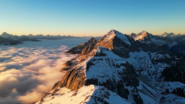 Wide aerial drone shot sweeping over sharp rocky mountain peaks submerged beneath a rolling inversion layer of clouds journey, submerged, rolling