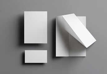 Blank white papers & cards A flat-lay with a folded leaflet, neutral gray