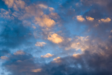 Fototapeta premium Soft golden hues illuminate scattered clouds against a blue sky above the Adriatic Sea. The scene highlights subtle gradients and natural textures in a peaceful, open skyscape.