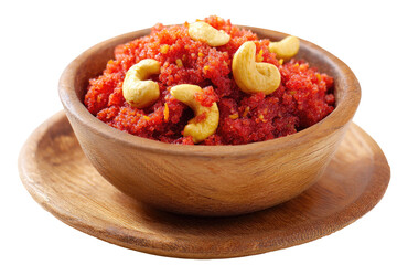 Red sweet dish in wooden bowl, topped with cashews