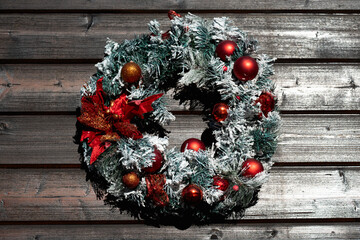 Festive Christmas wreath on a dark wooden door