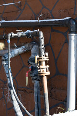 Insulation of external water pipes concept . Rusty exterior pipes and valves