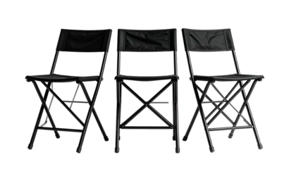 Three black folding chairs, arranged front facing against a deep black background