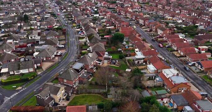 Aerial drone footage of the village of Huntington in the City of York North Yorkshire England showing rows of typical British houses and housing estates with roads, streets and gardens in the winter