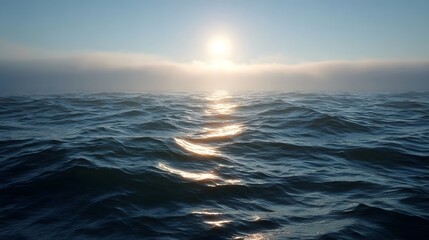 Obraz premium Golden sun rays pierce atmospheric fog over tranquil ocean at dawn