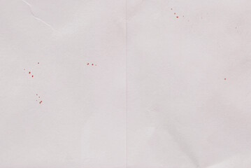 A sheet of old folded paper with spots as background