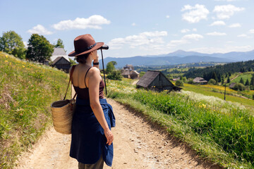 Woman walking on a dirt road in the mountains