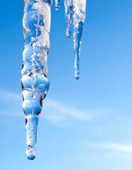 A close-up of a melting icicle's water droplet. Generative AI