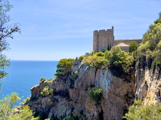spectacular view towards the public Torre de Guaita de Sant Sebastia de la Guarda tower on high cliffs at the Mediterranean Sea near Llfranc, Costa Brava, Girona, Catalonia, Spain