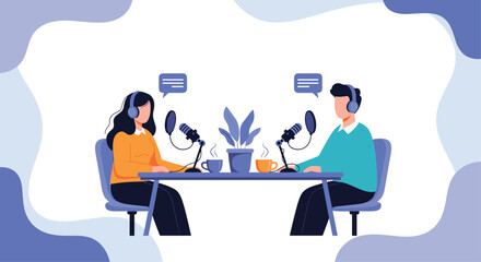 Man and woman hosting a live radio show or podcast interview sitting at a table with microphones and headphones on.
