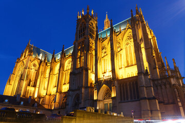 View on the beautiful illuminated cathedral in Metz at night . The construction took three centuries to complete the cathedral, which was consecrated in 1552.
