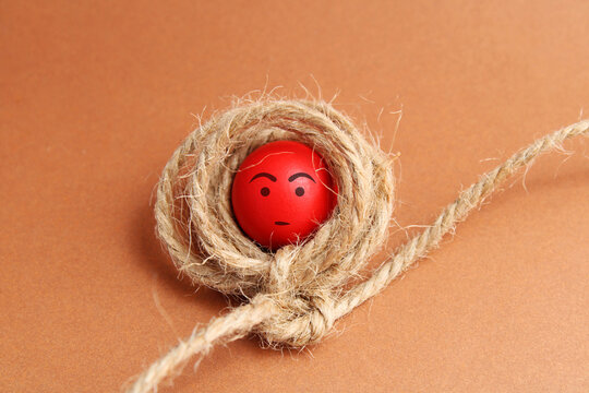 Sphere trapped by conflicts represented with a tied rope