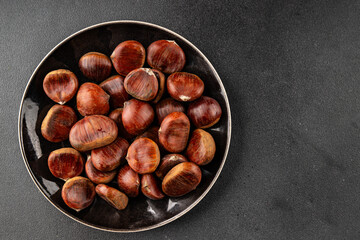 Obraz premium Edible chestnuts delicious treat tasty snack fresh gourmet food background on table rustic food top view copy space