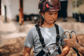 Young Girl Learning Safety Gear at Adventure Park &ndash; Outdoor Training Moment