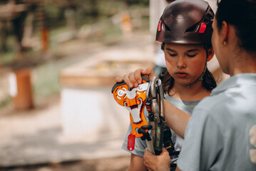 Young Girl Learning Safety Gear at Adventure Park &ndash; Outdoor Training Moment