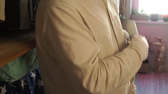 a man gets dressed and gets ready for work early in the morning