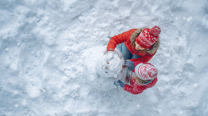 Top view of joyful mother and toddler daughter building a snowman together in snowy forest wearing winter clothing with bright cheerful atmosphere and realistic textures
