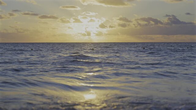 Waves splashing in the ocean at sunrise in the Riviera Maya, Mexico