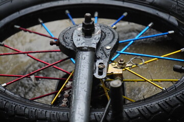 Close-up of a colorful motorcycle wheel with spokes and tire.
