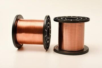 Copper coils on a white background. Copper wire for electronics. Pure copper.