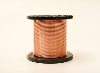 Copper coils on a white background. Copper wire for electronics. Pure copper.