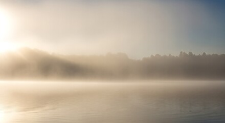 Fototapeta premium Misty Morning on the Lake with Sun Rays and Forest Reflection.