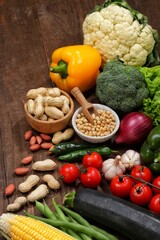 Various fresh healthy products on black background. Healthy food clean eating selection: fruit, vegetable, seeds, superfood, leaf vegetable on black background
