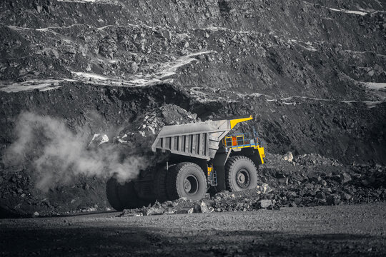 Open-pit coal mining in winter with heavy machinery operating in cold environment