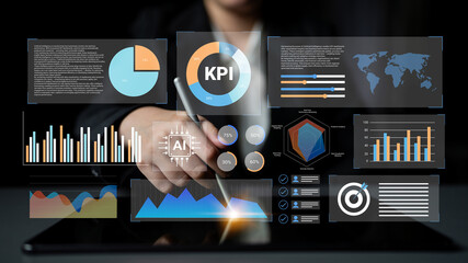 A business professional engages with a digital interface, showcasing various charts and graphs. This image illustrates data analysis and decision-making in a modern workspace. Gantry