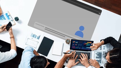 A dynamic collaborative workspace featuring professionals engaged in project discussions using laptops and tablets, showcasing insights through data analytics and visual presentations. Raster