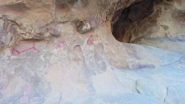 Ancient petroglyph carvings visible along Baker Dam Trail inside Joshua Tree National Park desert landscape in California