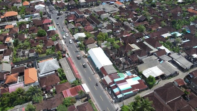 Drone view of one of the main roads in Bedulu, Bali, Indonesia, and the surrounding urbanization