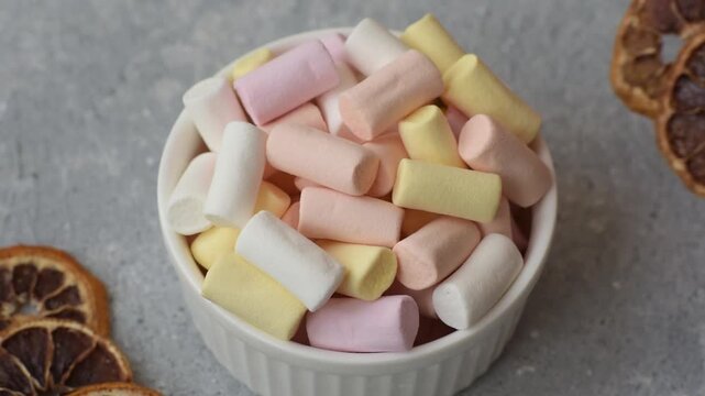 Mini marshmallows in white, pink, and pastel colors, a colorful Christmas dessert. Marshmallows as a food background for your design