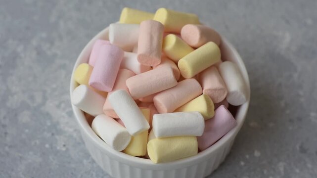 Mini marshmallows in white, pink, and pastel colors, a colorful Christmas dessert. Marshmallows as a food background for your design