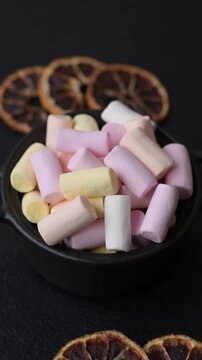 Mini marshmallows in white, pink, and pastel colors, a colorful Christmas dessert. Marshmallows as a food background for your design