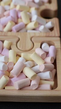 Mini marshmallows in white, pink, and pastel colors, a colorful Christmas dessert. Marshmallows as a food background for your design