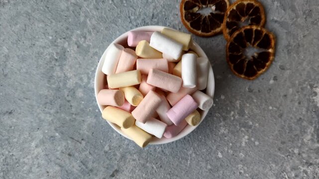 Mini marshmallows in white, pink, and pastel colors, a colorful Christmas dessert. Marshmallows as a food background for your design