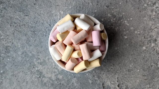 Mini marshmallows in white, pink, and pastel colors, a colorful Christmas dessert. Marshmallows as a food background for your design