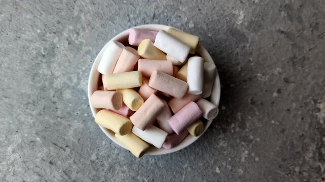 Mini marshmallows in white, pink, and pastel colors, a colorful Christmas dessert. Marshmallows as a food background for your design