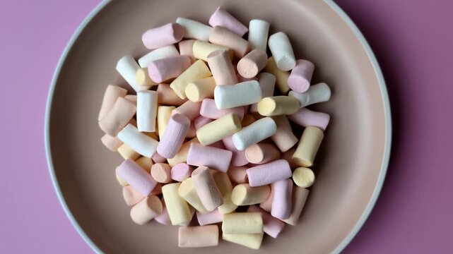 Mini marshmallows in white, pink, and pastel colors, a colorful Christmas dessert. Marshmallows as a food background for your design