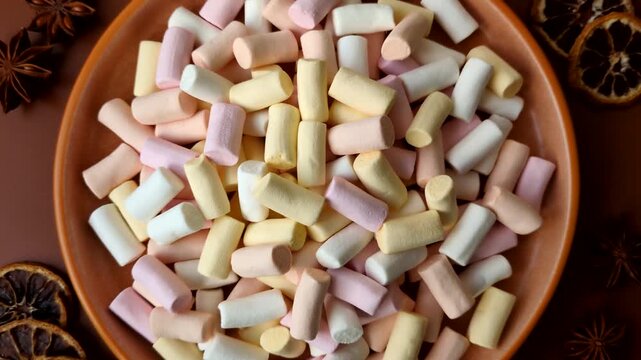 Mini marshmallows in white, pink, and pastel colors, a colorful Christmas dessert. Marshmallows as a food background for your design